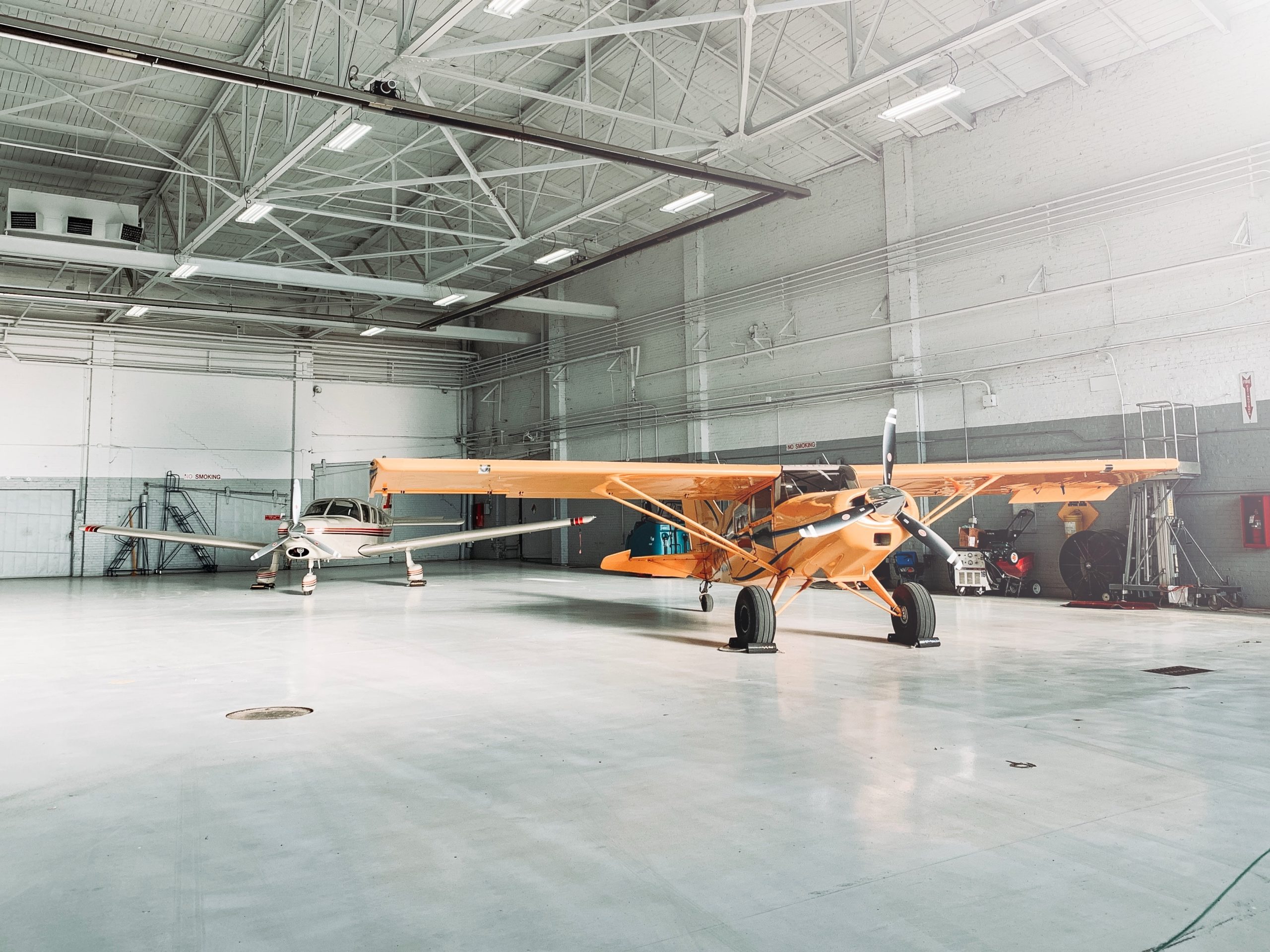 daniel-day-media-9gW_sOssTRw-unsplash plane in a hanger