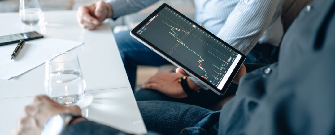 people looking at data on a tablet